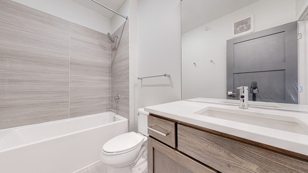 a bathroom with a toilet sink and bathtub