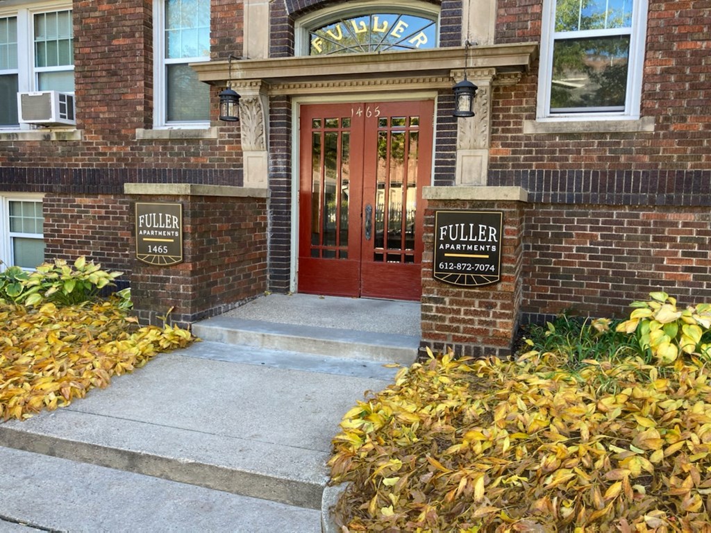 a brick building with a red door