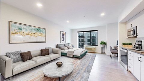 A modern living room with a grey sofa and a coffee table.
