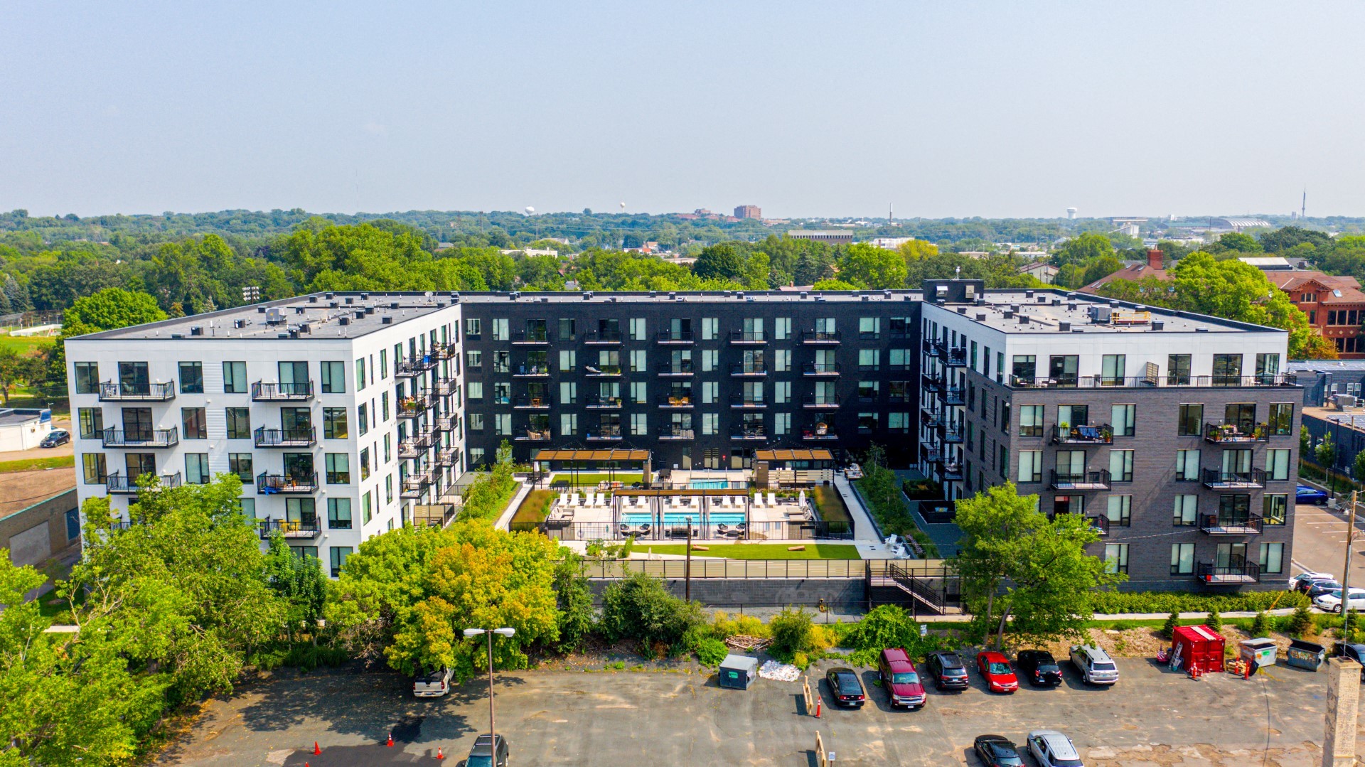 an aerial view of a large building with a pool in front of it
