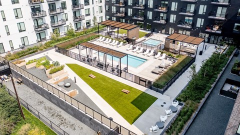an aerial view of an apartment complex with a pool and grassy area at The Mason, Minnesota, 55114