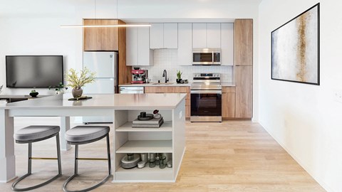 a modern kitchen with a white island with two stools