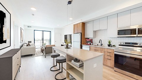 a kitchen with a large island and a living room