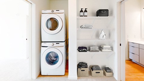 a white washer and dryer in a white laundry room