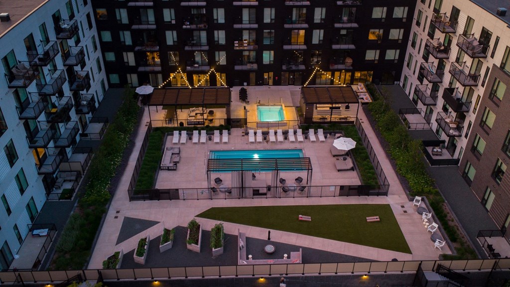 an aerial view of the courtyard of an apartment building with a pool