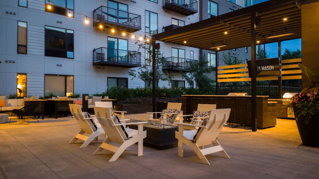 a patio with tables and chairs outside of a building