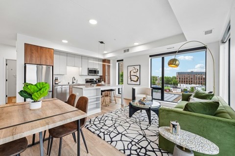 A modern kitchen with a dining table and chairs.