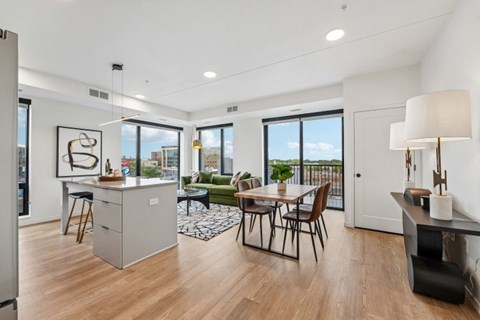 A modern kitchen with a dining table and chairs.