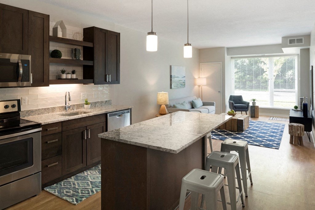 Kitchen Island Near Living Room at The McMillan Apartments in Shoreview, MN 55126