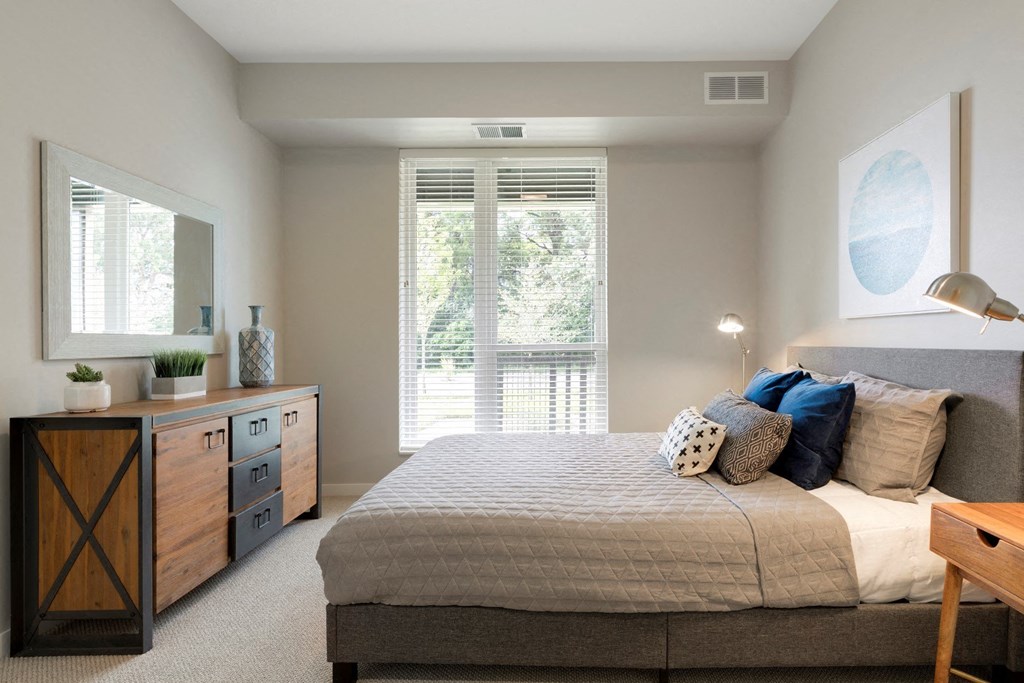 Master Bedroom With Balcony at The McMillan Apartments in Shoreview, MN 55126