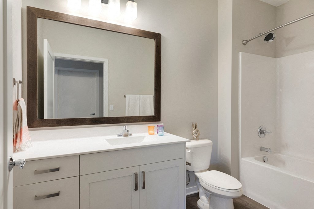 Bathroom With Mirror and Shower at The McMillan Apartments in Shoreview, MN 55126