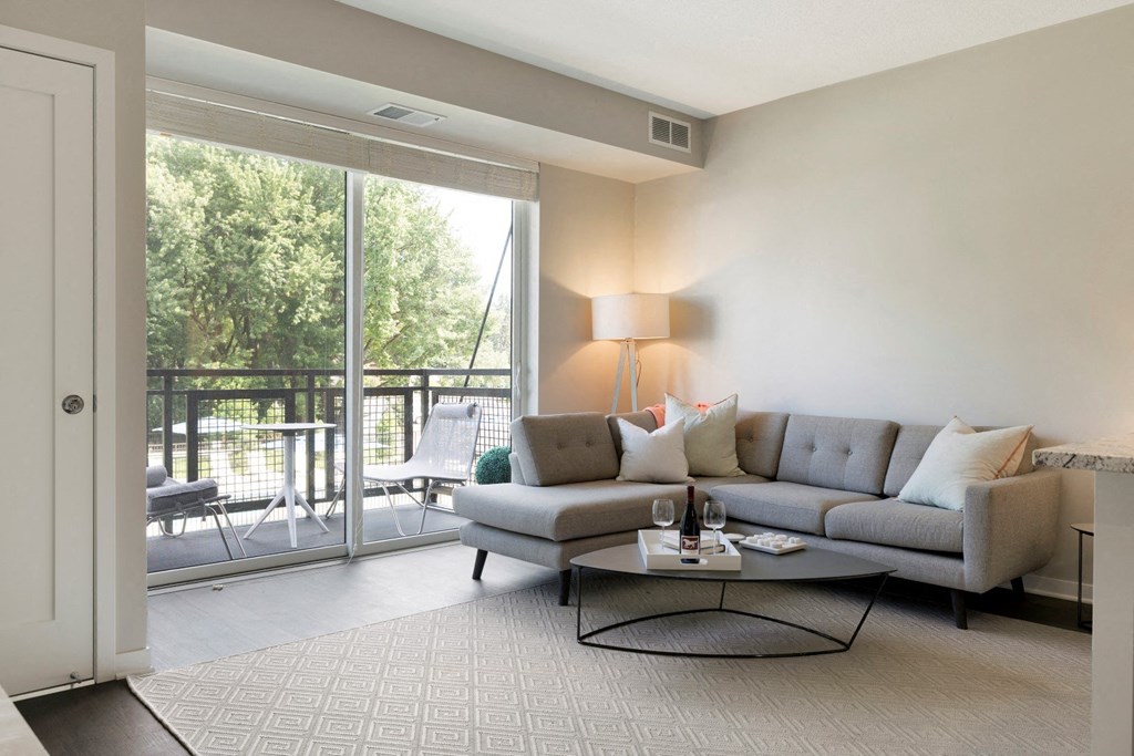 Living Room With Patio/Balcony at The McMillan Apartments in Shorview, MN 55126