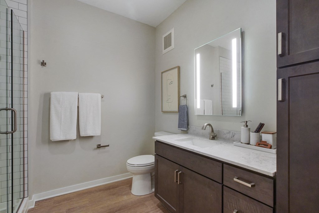 a bathroom with gray walls and a wooden floor