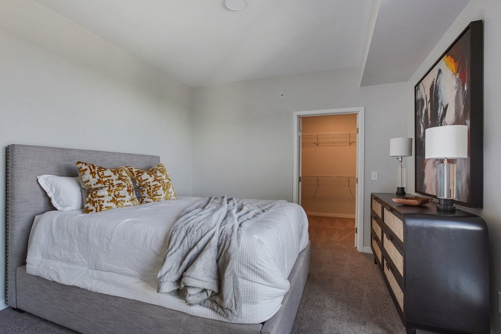 a bedroom with a bed and a dresser