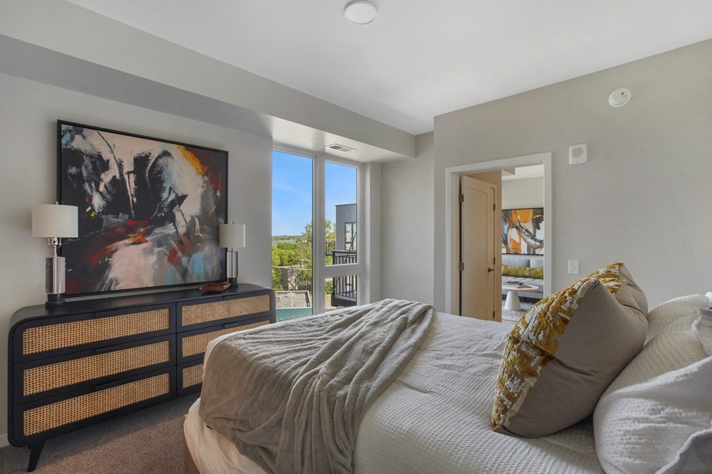 a bedroom with a large bed and a large window