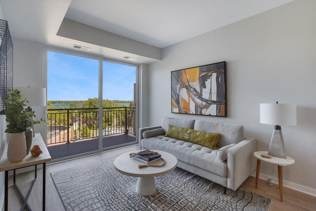 a living room with a couch coffee table and a large window