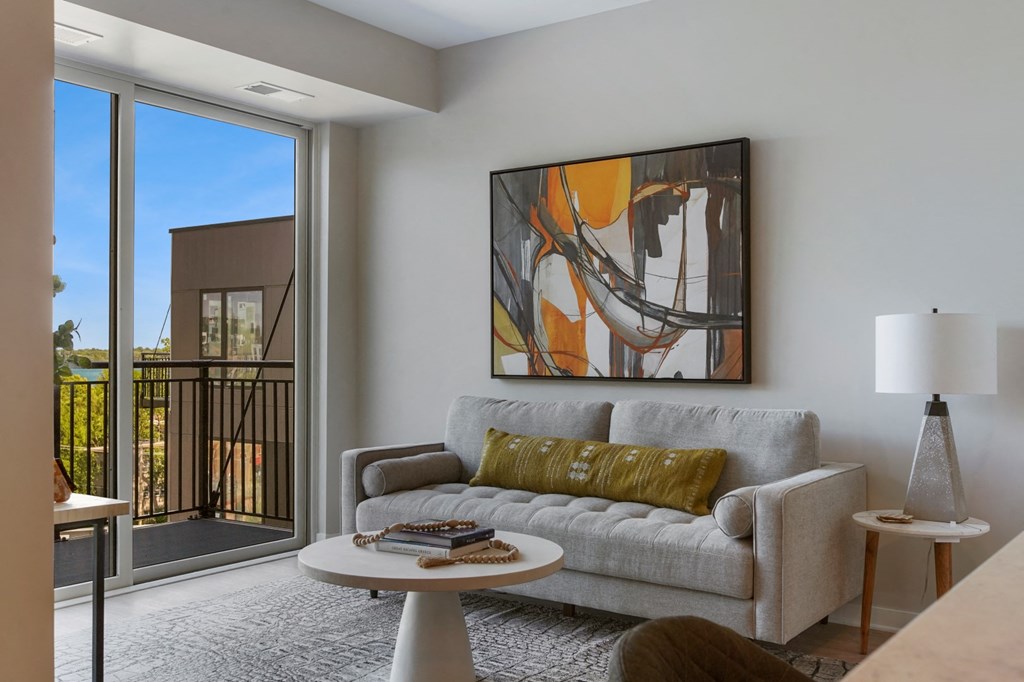 a living room with a couch a table and a window