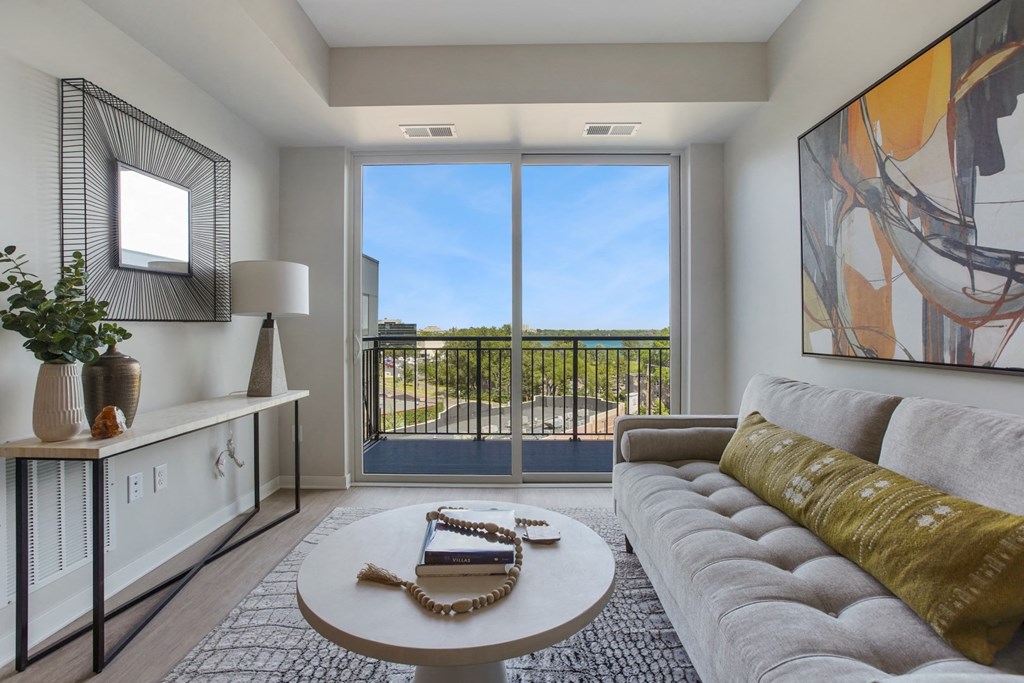 a living room with a couch coffee table and a large window
