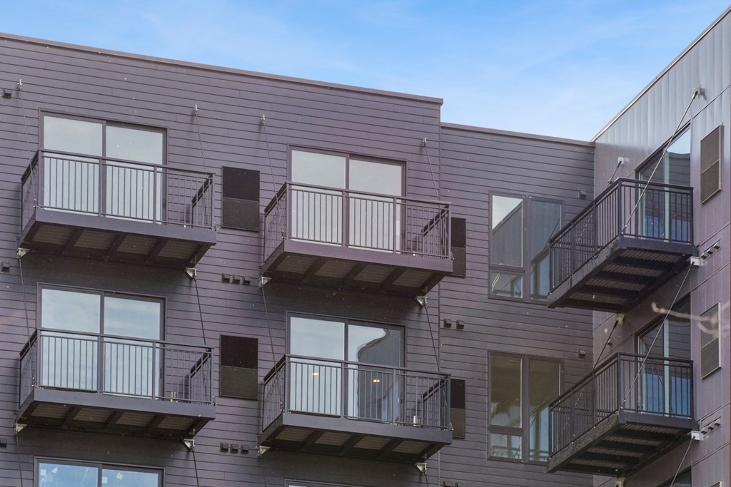 a view of the exterior of a building with multiple balconies