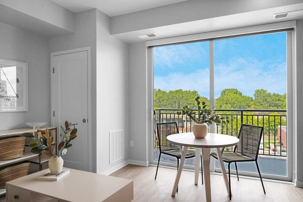 a seating area with a table and chairs in a 555 waverly unit