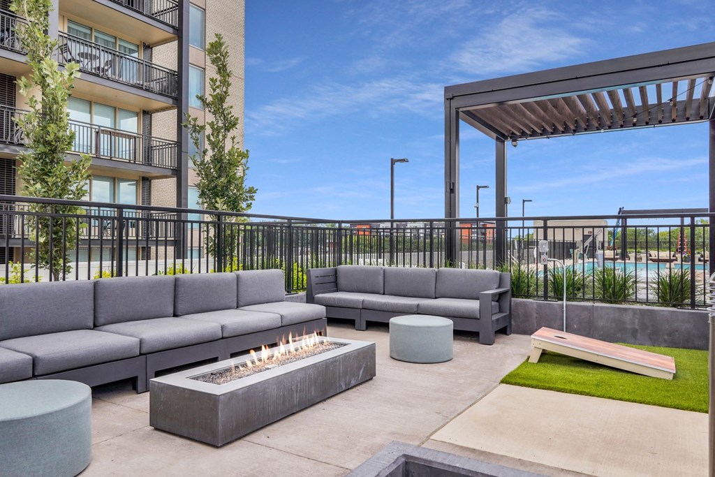 a patio with couches and a fire pit at the district flats apartments in lenexa