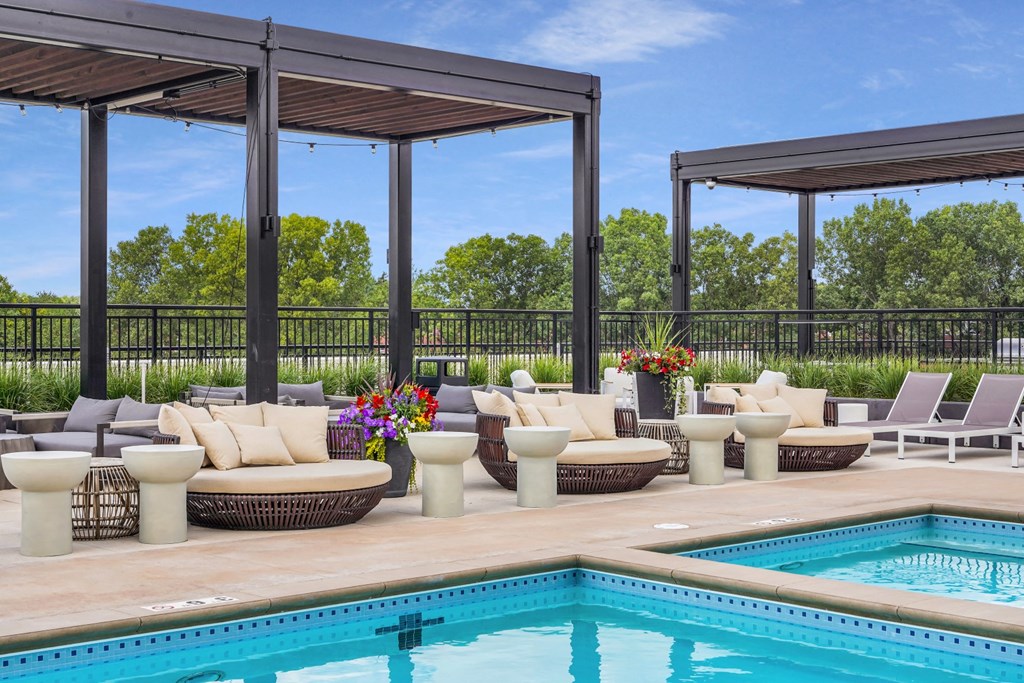 a pool and lounge area with couches and chairs at The Gateway at West Lake Quarter in Minneapolis, MN