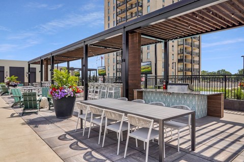 a patio with a table and chairs and a bar