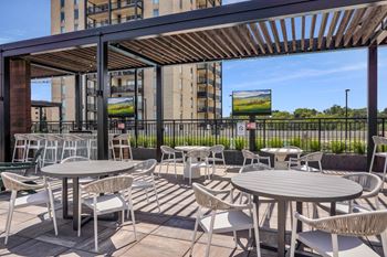 an outdoor patio with tables and chairs at The Gateway at West Lake Quarter in Minneapolis, MN