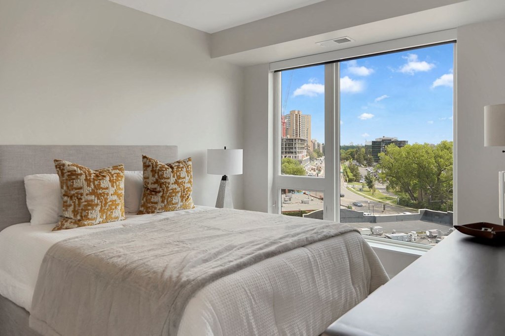 a bedroom with a large bed and a large window