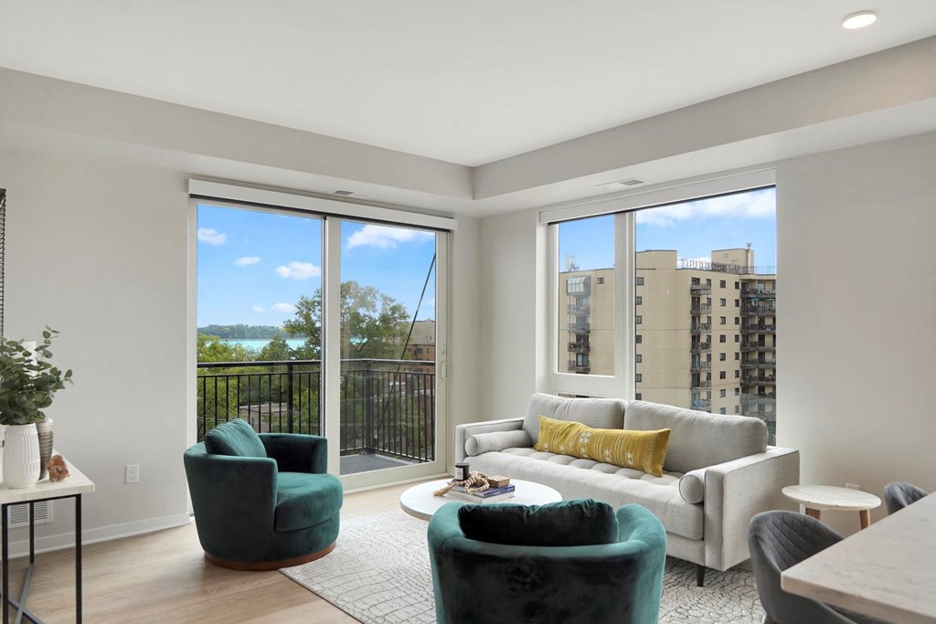 a living room with a large window and a balcony
