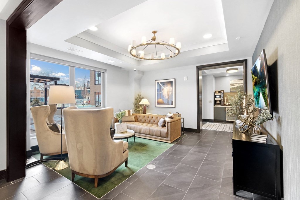 a living room with gray tile flooring and a chandelier hanging from the ceiling
