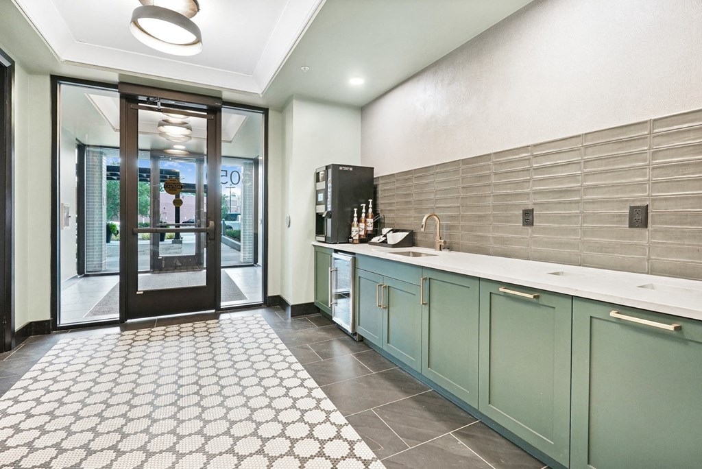 a kitchen with green cabinets and a white tile floor