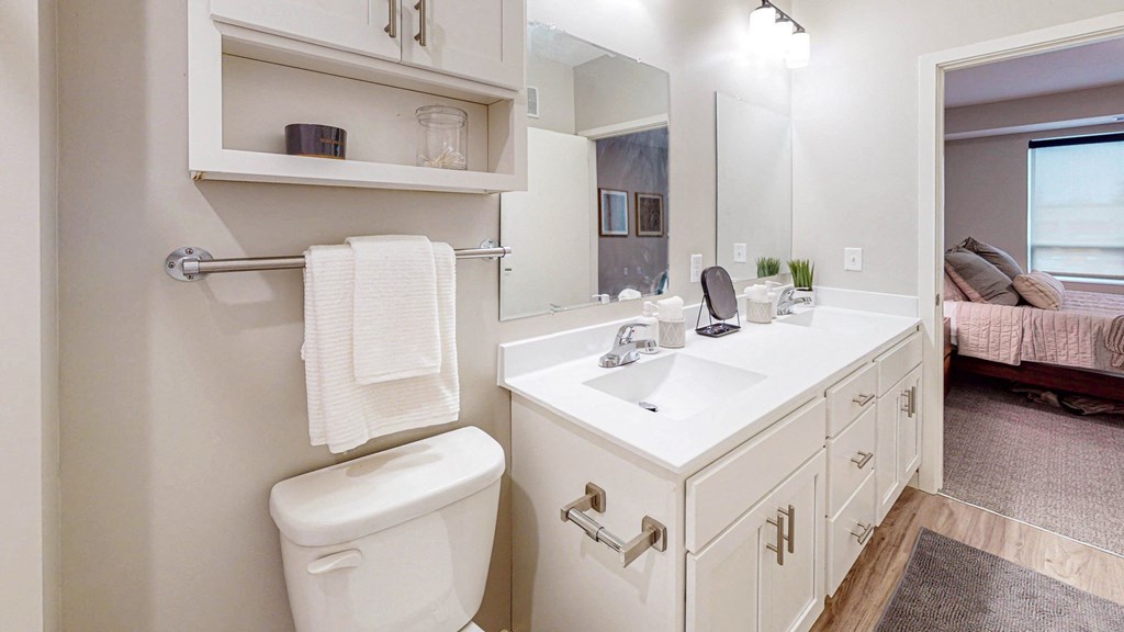 a bathroom with white cabinets and a white toilet at The Morrison, Rosemount, 55068