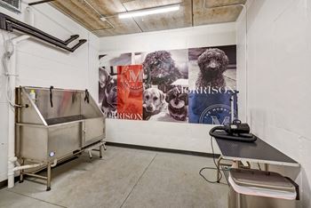 a large mural of dogs on a wall in a laundry room