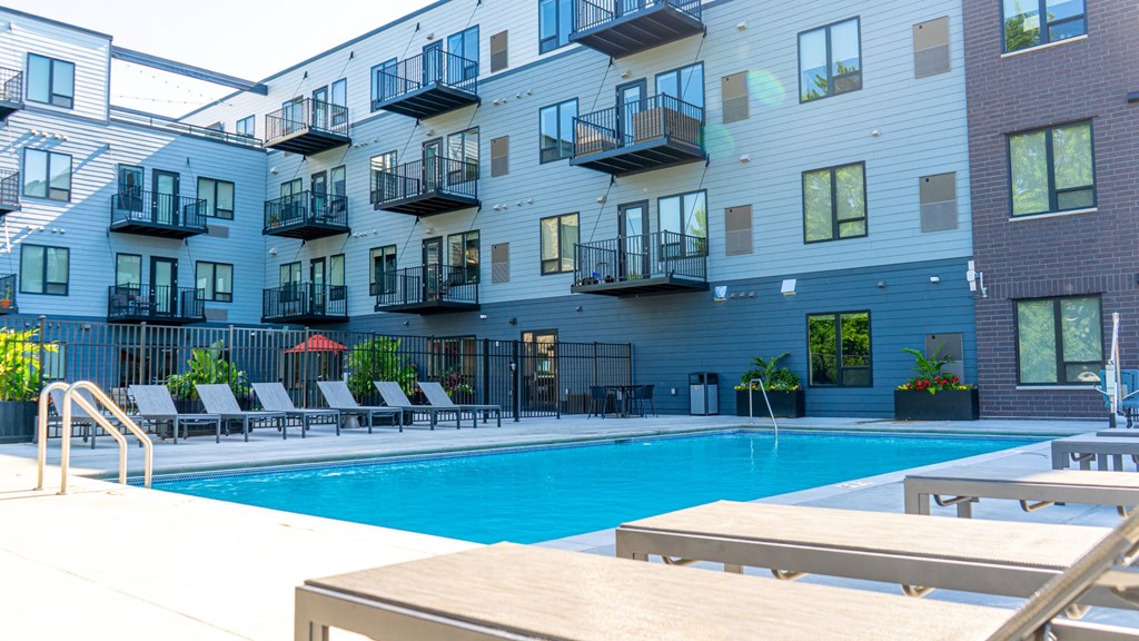 a swimming pool in front of an apartment building at The Morrison, Rosemount, MN
