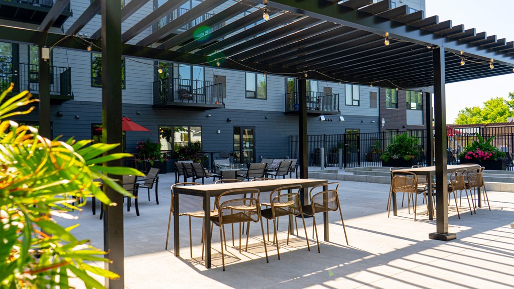 an outdoor patio with tables and chairs at The Morrison, Minnesota, 55068