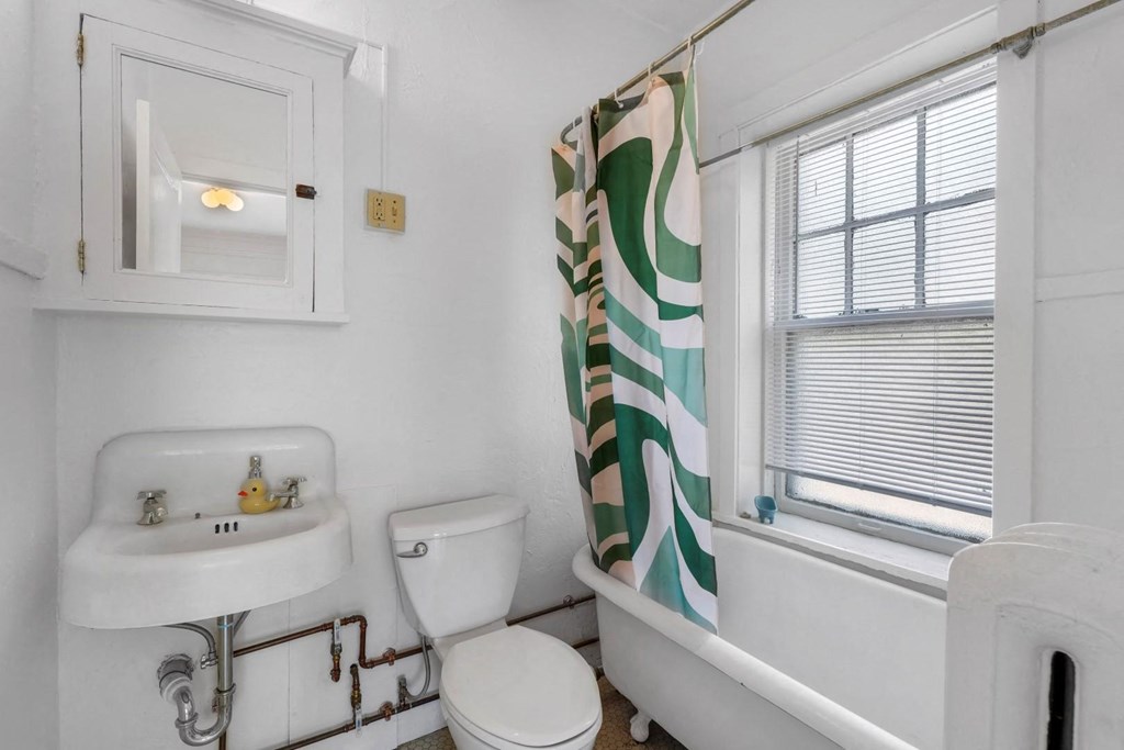 a bathroom with a sink toilet and bathtub