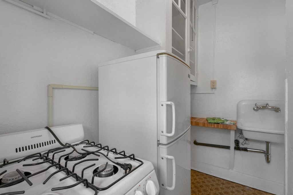 a kitchen with a stove and a refrigerator