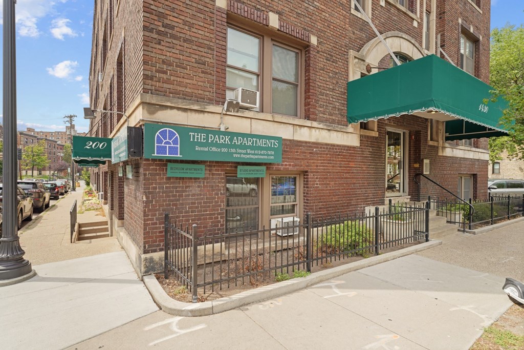 a building with a green awning and a sign that reads the park condominiums