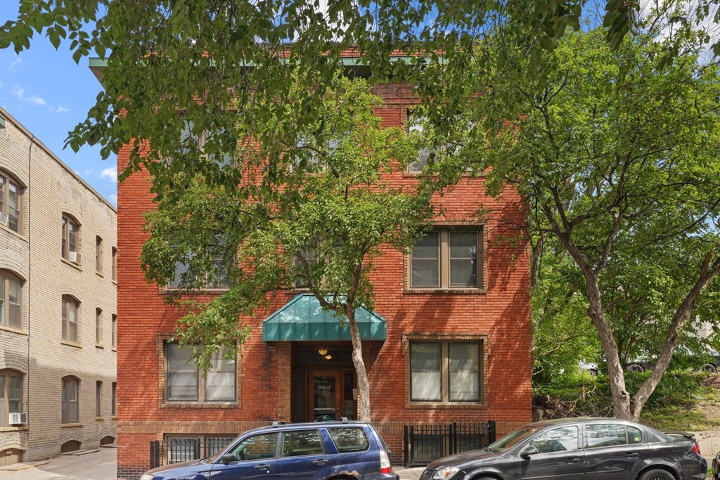 a red brick building with a green awning
