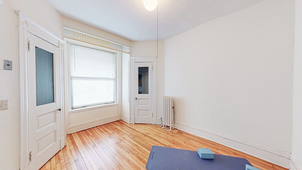 A room with a blue mat on the floor.