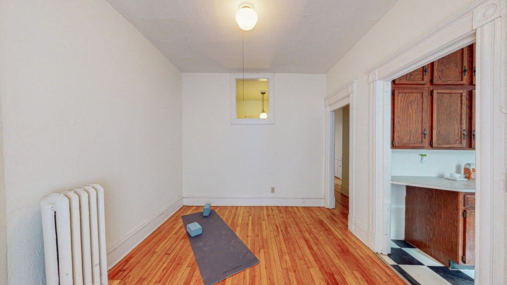 A room with a yoga mat on the floor.