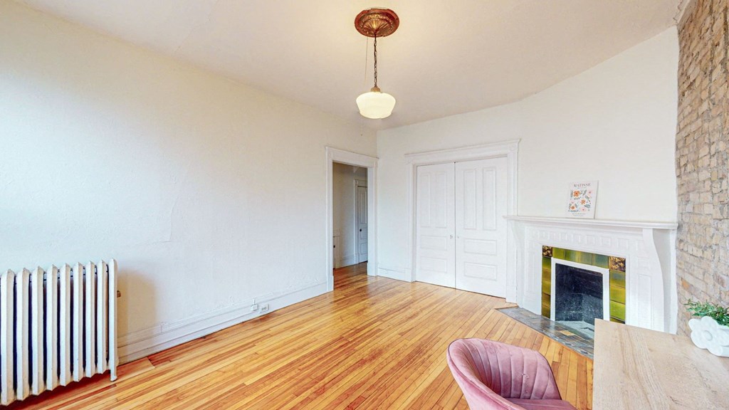 A room with a fireplace and a chair.