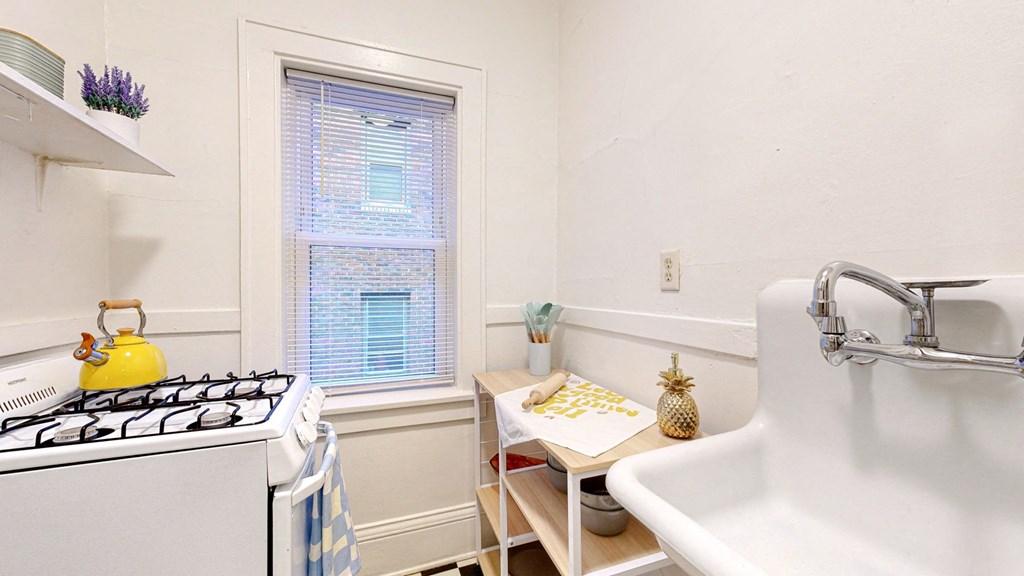 a small kitchen with a sink and stove