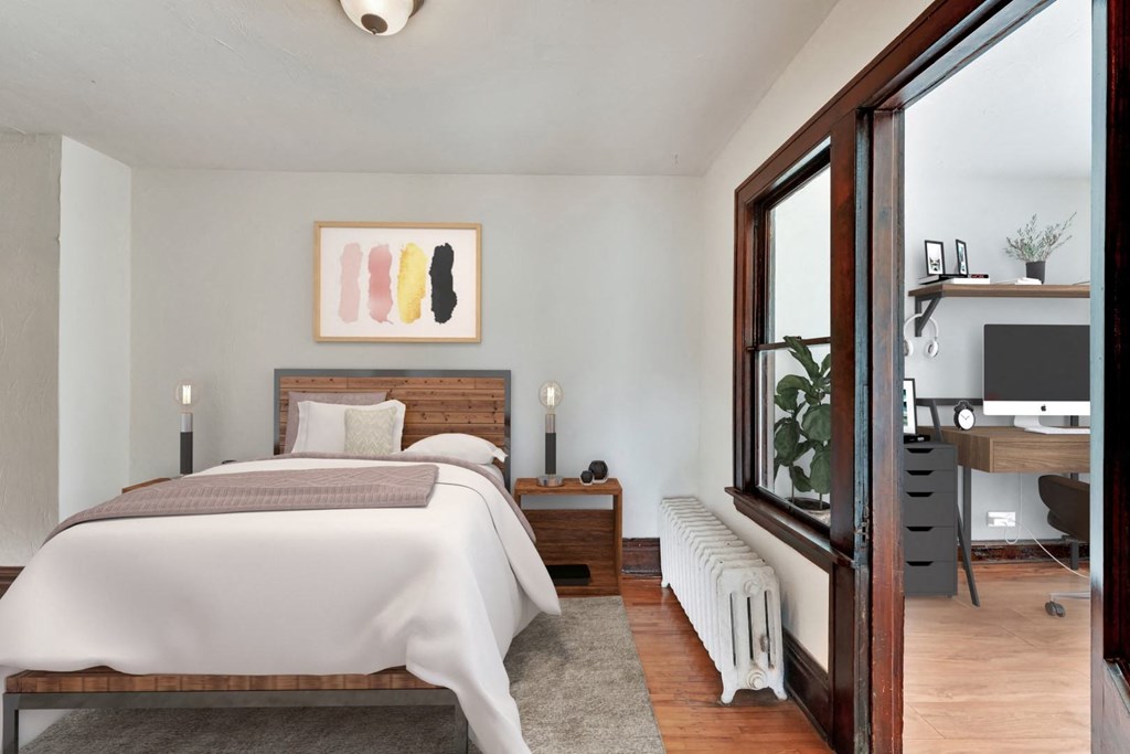 a bedroom with a bed and a window