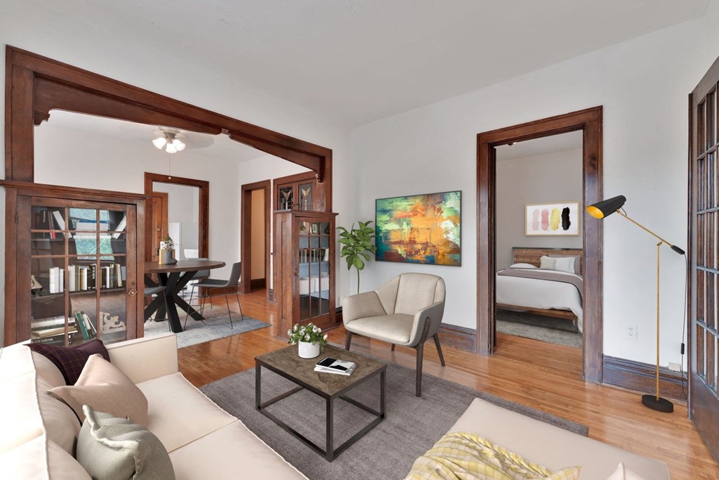 a living room filled with furniture and a large window