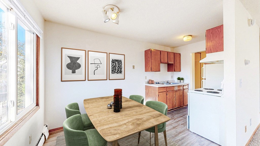 a dining room table with a kitchen in the background
