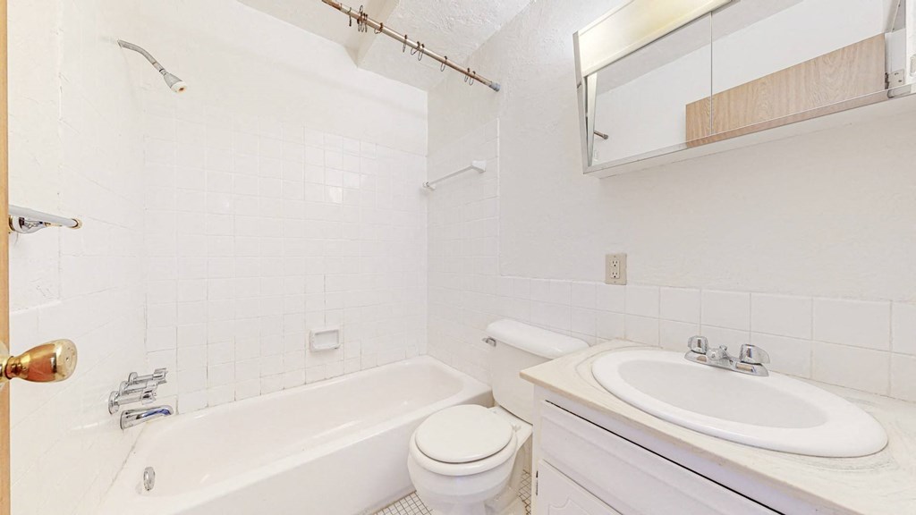 a bathroom with a sink toilet and bathtub