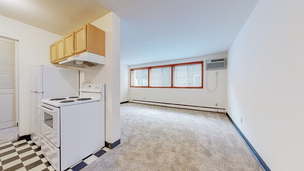 a kitchen with white appliances and a black and white checkered floor