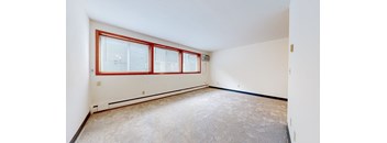 a bedroom with white walls and a large window